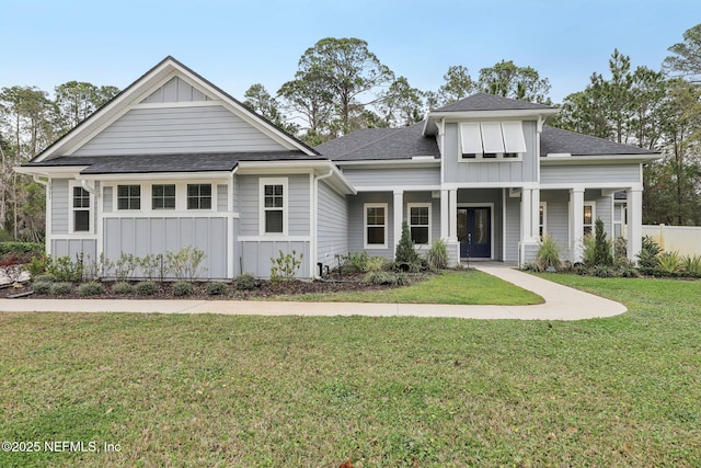 1351 Weaver Glen Rd, Jacksonville, FL 32223 - view of front of property featuring board and batten siding, roof with shingles, a porch, and a front lawn
