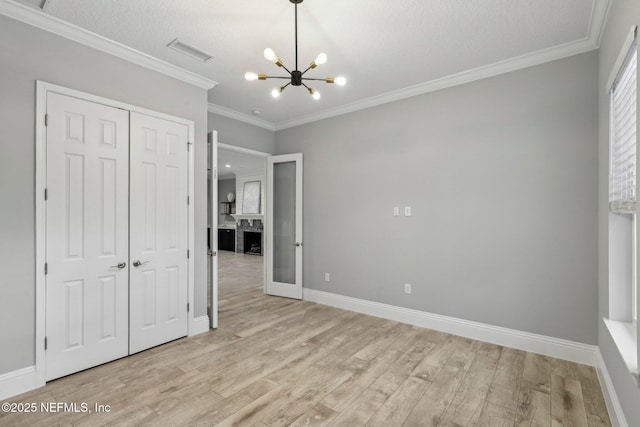 1351 Weaver Glen Rd, Jacksonville, FL 32223 - unfurnished bedroom with a closet, visible vents, crown molding, and light wood-style flooring