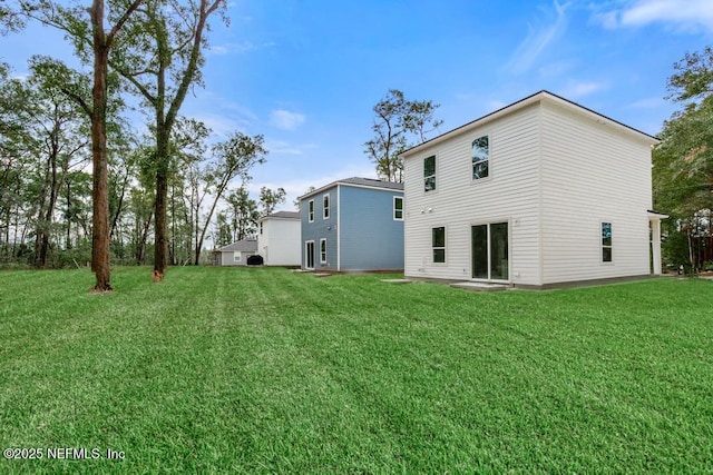 rear view of property with a lawn