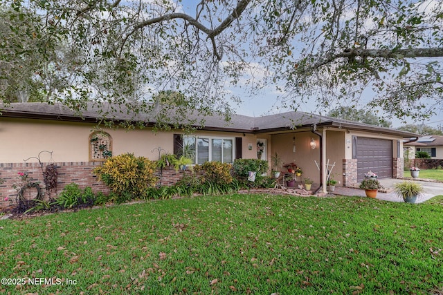 ranch-style house featuring a garage and a front lawn