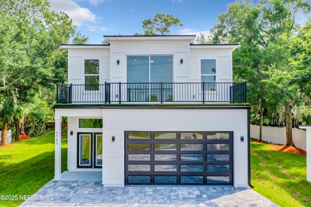 5765 Heckscher Dr, Jacksonville, FL 32226 - back of property with a yard, a garage, and a balcony