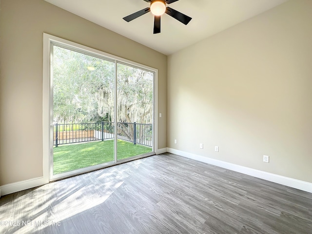 unfurnished room with hardwood / wood-style flooring and ceiling fan