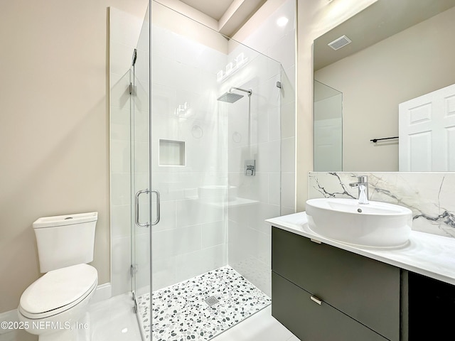 bathroom with walk in shower, tile patterned floors, vanity, and toilet