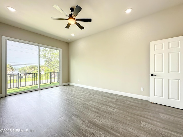 empty room featuring hardwood / wood-style floors and ceiling fan