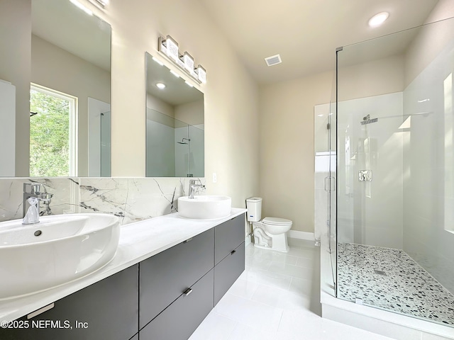 bathroom with vanity, toilet, an enclosed shower, and decorative backsplash