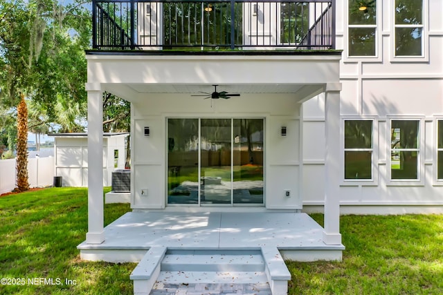 doorway to property featuring ceiling fan, a yard, central AC, a patio, and a balcony