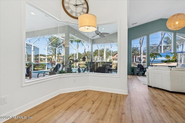 unfurnished dining area with wood-type flooring and ceiling fan