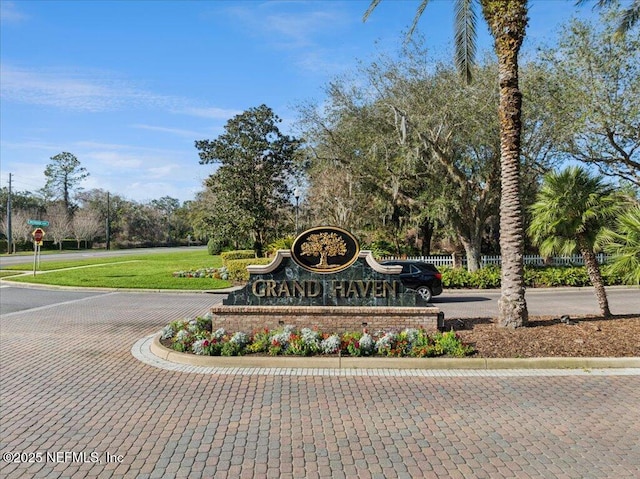 community / neighborhood sign with a yard