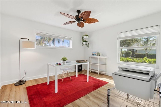 home office featuring hardwood / wood-style flooring and ceiling fan