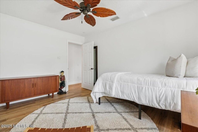 bedroom with hardwood / wood-style flooring and ceiling fan