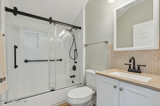 full bathroom with enclosed tub / shower combo, vanity, backsplash, and toilet