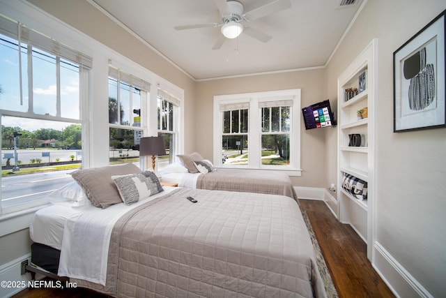 bedroom with baseboards, visible vents, ornamental molding, and dark wood finished floors