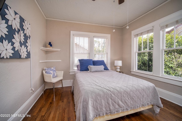 bedroom featuring ornamental molding, wood finished floors, and baseboards