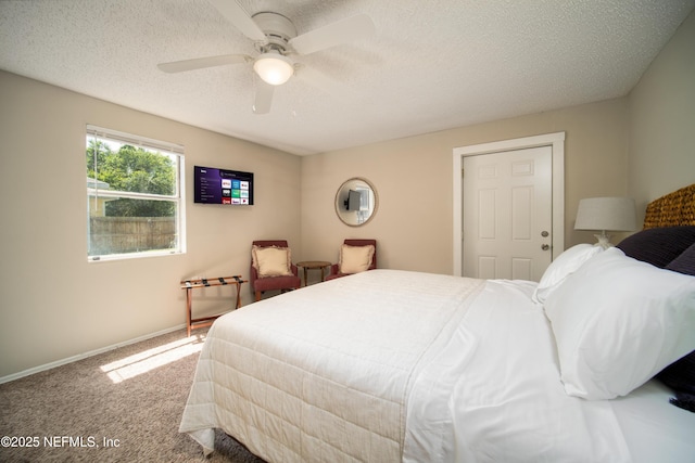 bedroom with a ceiling fan, carpet, baseboards, and a textured ceiling