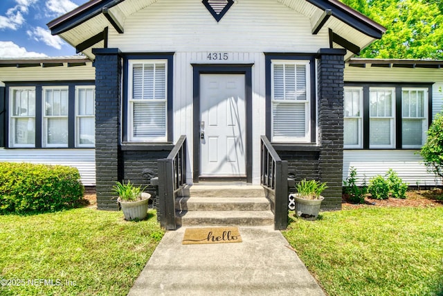 property entrance with a yard