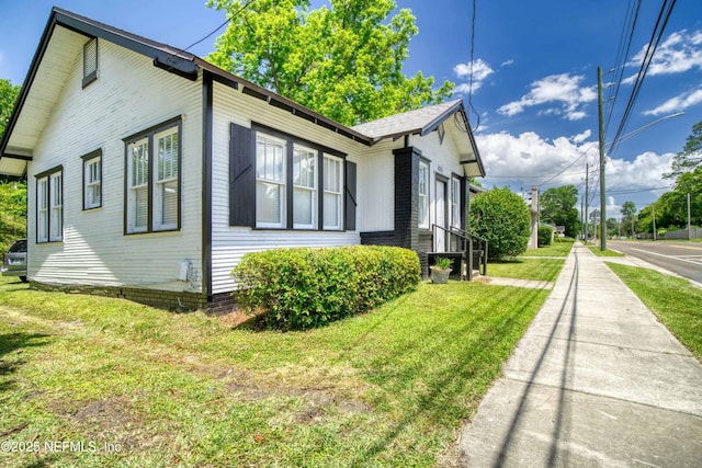 view of property exterior featuring a lawn