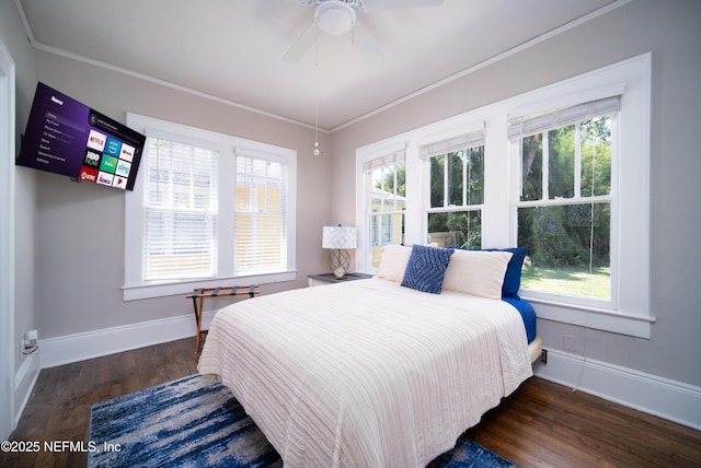 bedroom featuring crown molding, ceiling fan, wood finished floors, and baseboards