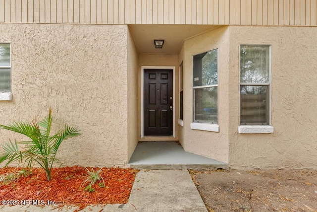 doorway to property with stucco siding