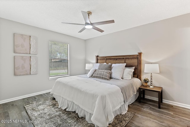 bedroom with ceiling fan, a textured ceiling, wood finished floors, and baseboards