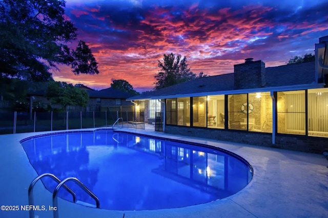 view of swimming pool featuring a patio, fence, and a fenced in pool