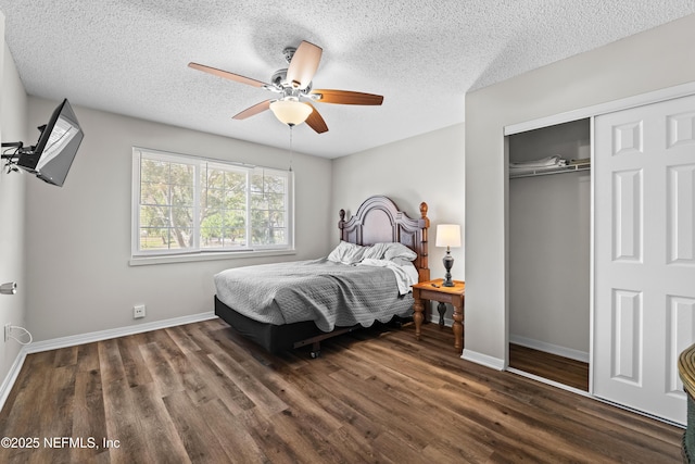 bedroom with a closet, baseboards, and dark wood-style floors