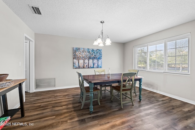 dining area featuring visible vents, baseboards, a chandelier, and dark wood-style flooring