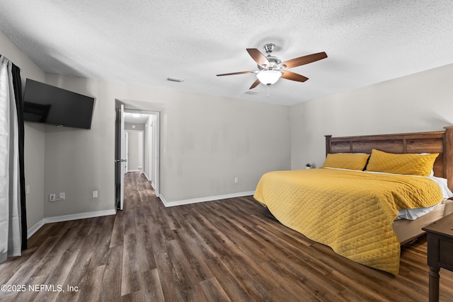 unfurnished bedroom with baseboards, a textured ceiling, wood finished floors, and a ceiling fan