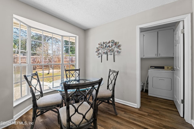 dining area with dark wood-type flooring, washer / clothes dryer, and a wealth of natural light