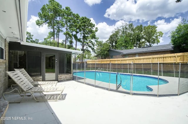 view of swimming pool with a fenced in pool, fence, and a patio area