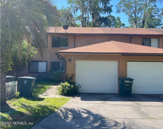 view of front of property with a garage and concrete driveway