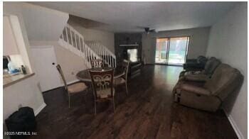 dining room with stairs and wood finished floors