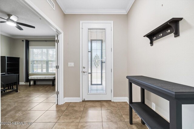 foyer with crown molding, tile patterned floors, and ceiling fan