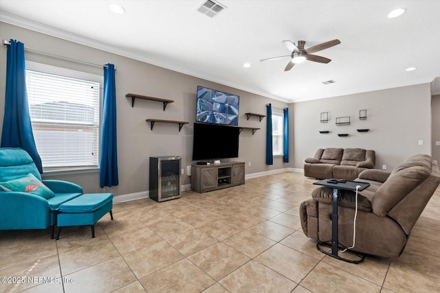 living room with ceiling fan, ornamental molding, and light tile patterned floors