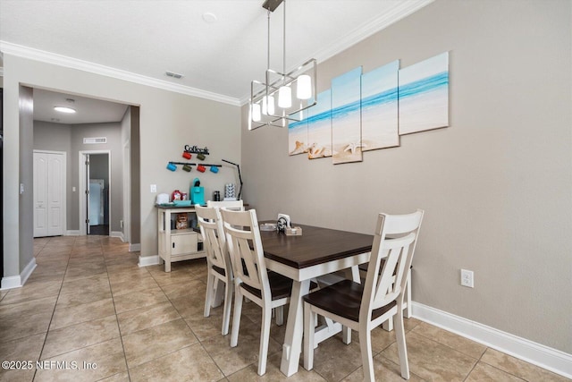 tiled dining space featuring ornamental molding