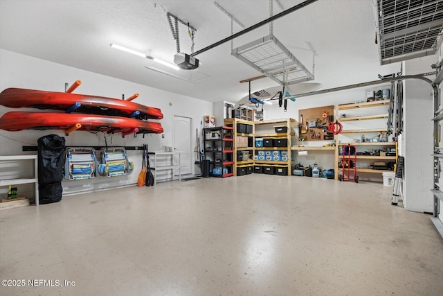 garage featuring a garage door opener and a workshop area