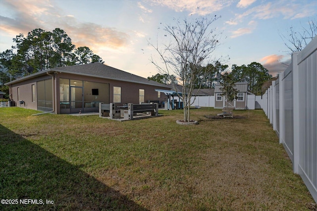 yard at dusk with an outdoor living space and a shed