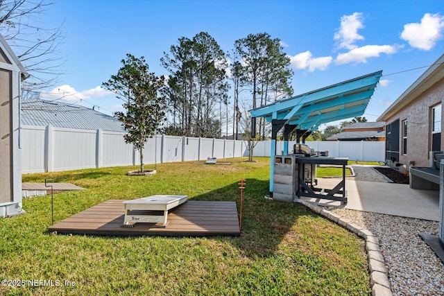 view of yard with a wooden deck and a patio