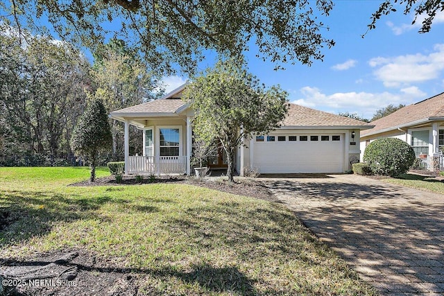 view of front facade with a front lawn, a garage, and a porch