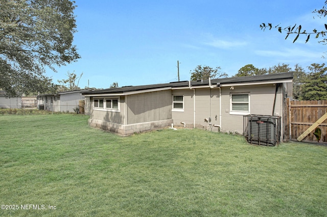 rear view of property featuring a yard