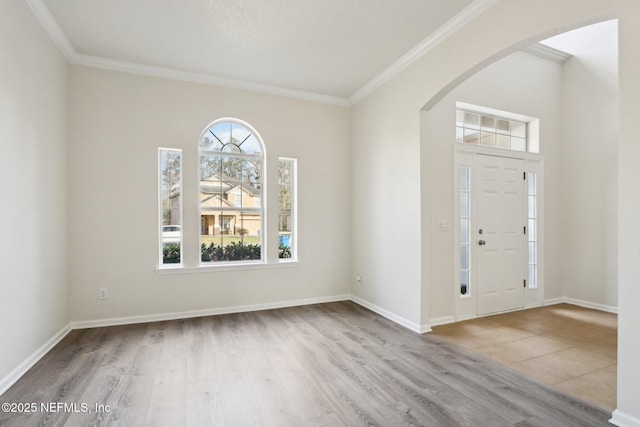 entryway with crown molding and light wood-type flooring