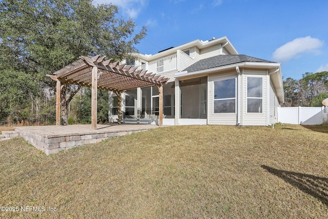 rear view of property featuring a patio, a sunroom, a lawn, and a pergola