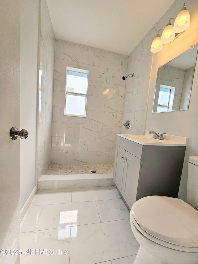 2434 Leonid Rd, Jacksonville, FL 32218 - bathroom featuring a tile shower, vanity, and toilet