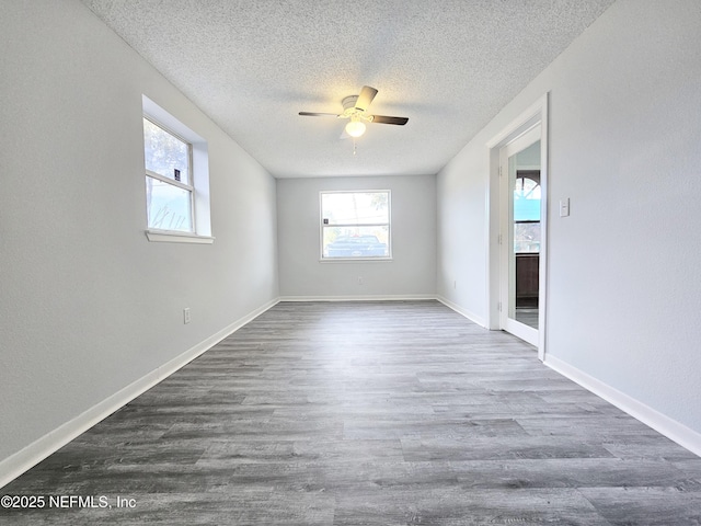 2434 Leonid Rd, Jacksonville, FL 32218 - spare room with dark wood-type flooring, a textured ceiling, and ceiling fan