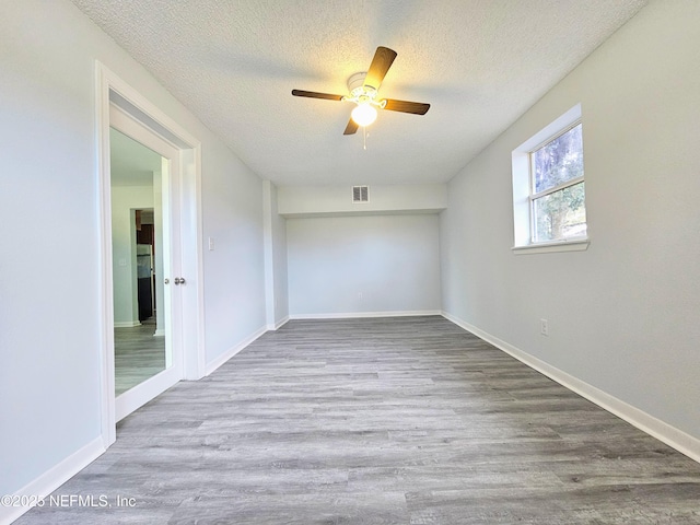 2434 Leonid Rd, Jacksonville, FL 32218 - unfurnished room featuring ceiling fan, hardwood / wood-style flooring, and a textured ceiling