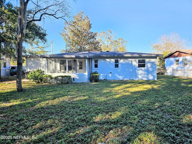 2434 Leonid Rd, Jacksonville, FL 32218 - rear view of property featuring a lawn