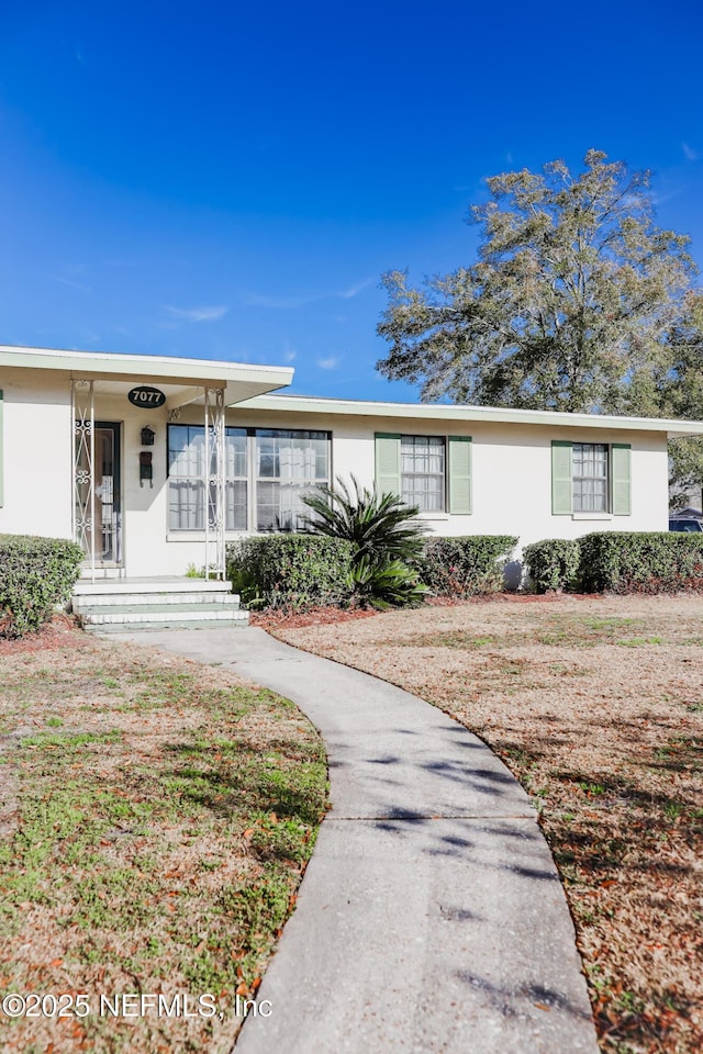 ranch-style house with covered porch