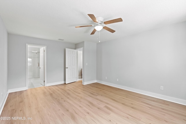 unfurnished bedroom with ceiling fan, ensuite bathroom, and light hardwood / wood-style flooring