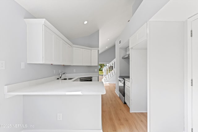 kitchen with dishwashing machine, sink, white cabinetry, electric range, and kitchen peninsula