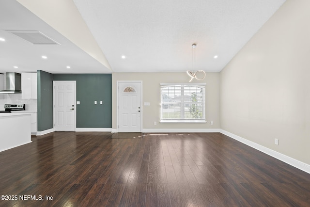 interior space featuring vaulted ceiling and dark wood-type flooring