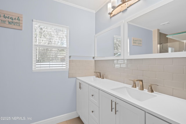 bathroom featuring tasteful backsplash, ornamental molding, and vanity